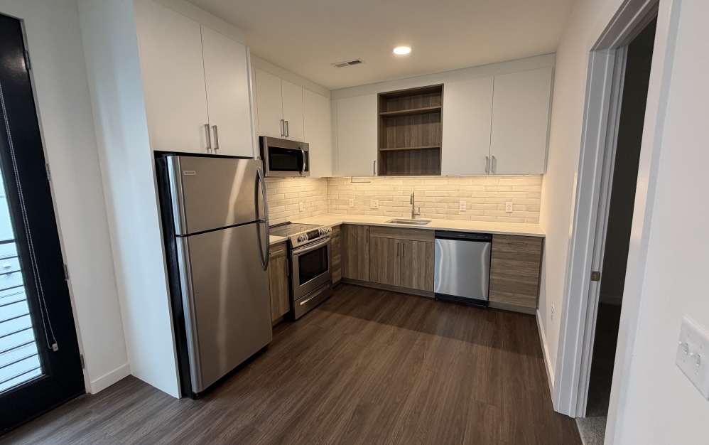 one bedroom apartment kitchen with storage space and stainless steel appliances