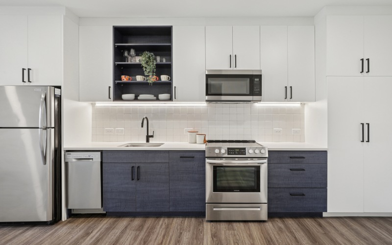 Two toned cabinetry with stainless steel appliances
