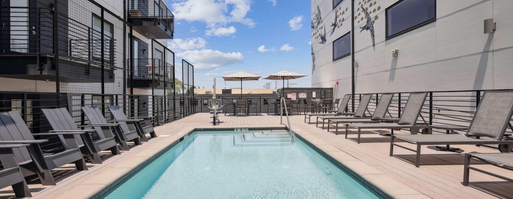 Sparkling pool in a courtyard with lounge seating
