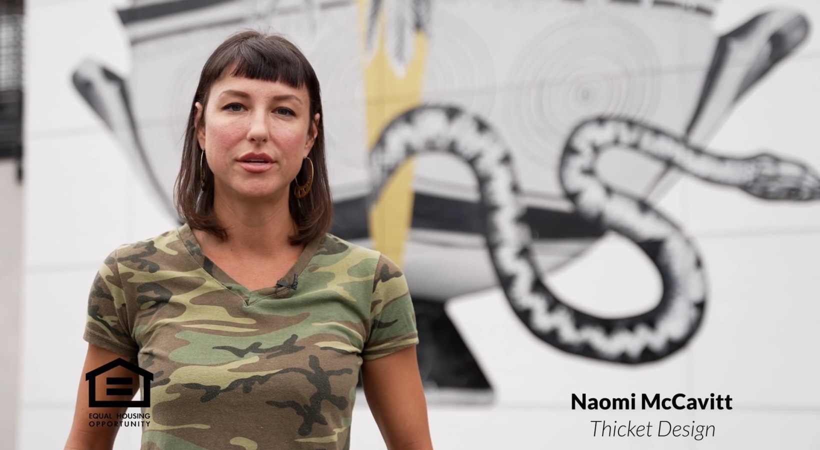 a person standing in front of a mural
